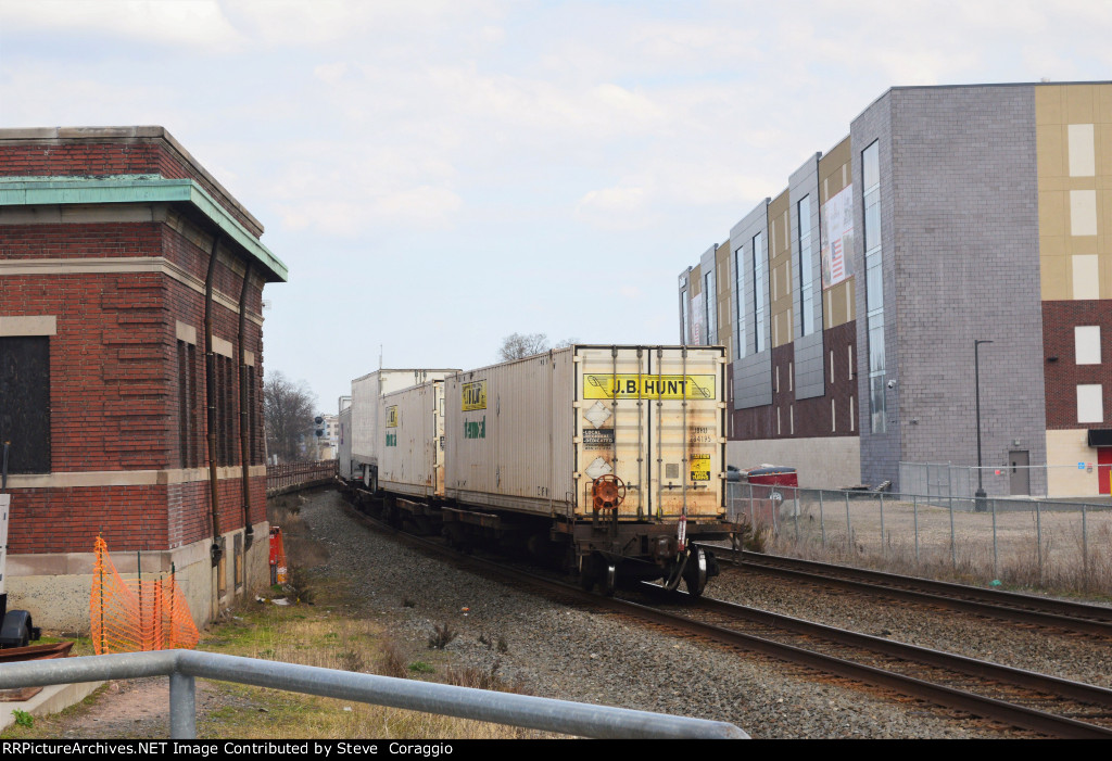  Tail end of 28X passes between the old CNJ Station and Self Storage Facility.   